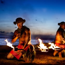 Tangerine Travel - Hawaiian poi dancers spin fire on a sunset beach. Join us for a Ho`olaule`a!