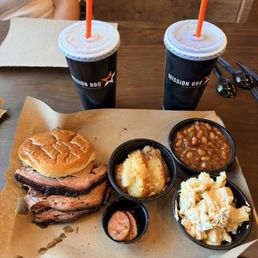 Moist brisket sandwich with sides of baked beans and brisket, potato salad & peach cobbler Moist brisket sandwich with sides of baked beans and brisket, potato salad & peach cobbler