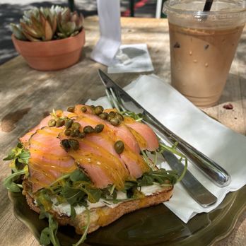 Kos Coffee - Smoked Salmon Toast: Sourdough with cream cheese, capers, arugula and a sweet mustard dill sauce - Acai Bowls Near Me - San Diego, California Kos Coffee - Smoked Salmon Toast: Sourdough with cream cheese, capers, arugula and a sweet mustard dill sauce - Acai Bowls Near Me - San Diego, California