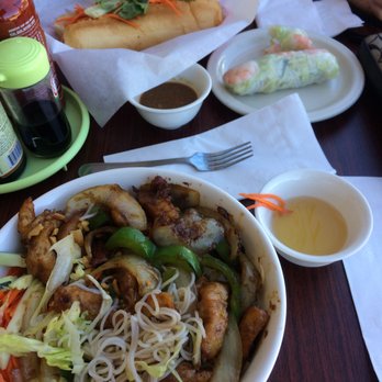 Yummy Banh Mi - Lemongrass chicken vermicelli bowl in the foreground and chicken banh mi and spring rolls in the back. - Vietnamese Near Me - Everett, Washington
