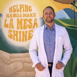 Thomas Ence - Coastal Concierge Physician - Dr Ence standing in front of mural on La Mesa blvd