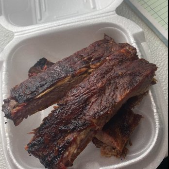 Fat Cat's Bar-B-Que - ows two ribs in a styrofoam container - Food Trucks Near Me Fat Cat's Bar-B-Que - ows two ribs in a styrofoam container - Food Trucks Near Me