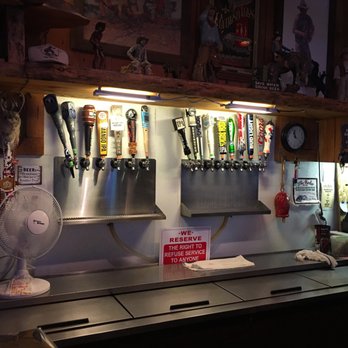 Rodeo Bar - a man standing in front of a row of beer taps - Bars Near Me - Paso Robles, California
