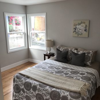 Bailey Construction - a bedroom with a large bed and two windows - General Contractors Near Me - Aptos, California Bailey Construction - a bedroom with a large bed and two windows - General Contractors Near Me - Aptos, California