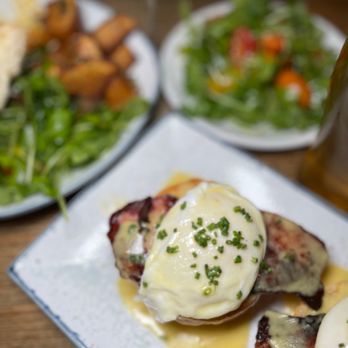 Cellar@42 - a plate of eggs benedict with a side salad - Tapas/Small Plates Near Me - Brooklyn, New York