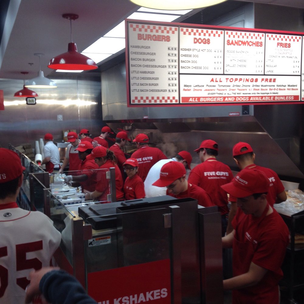 a line of workers in a fast food restaurant