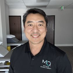 Joy Embroidery - Owner wearing an embroidered polo shirt.
