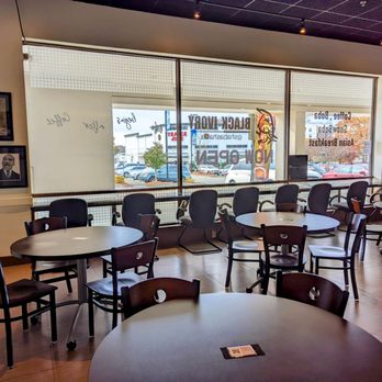 Black Ivory Café - tables and chairs in front of a window - Coffee & Tea Near Me - Raleigh, North Carolina