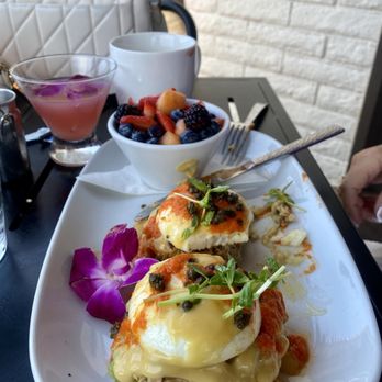 Brunch - Kitchen & Cocktails - Crab Cake Benedict w/fruit and the Paloma in the background - Breakfast & Brunch Near Me - Cave Creek, Arizona