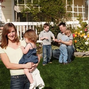 Weed Man - a woman holding a child in front of a house - Lawn Services Near Me - Winchester, Virginia Weed Man - a woman holding a child in front of a house - Lawn Services Near Me - Winchester, Virginia