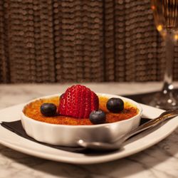 Mpire Club - Vanilla Creme Brulee garnished with fresh berries