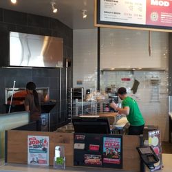 Hard at work, stuffing that oven full of tasty pizzas