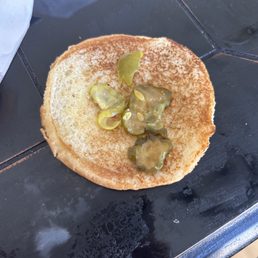 ows a pancake with pickles on it