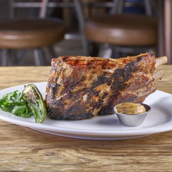 The Rustic - Triple Chop, a wood-grilled bone-in pork chop with BBQ Butter. - Venues & Event Spaces Near Me - Houston, Texas The Rustic - Triple Chop, a wood-grilled bone-in pork chop with BBQ Butter. - Venues & Event Spaces Near Me - Houston, Texas