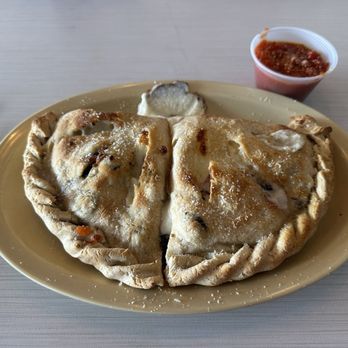 Memphis Pizza Cafe - Build your own Calzone. This one contained artichokes, sun-dried tomatoes, black olives, and onions. - Pizza Near Me - Memphis, Tennessee Memphis Pizza Cafe - Build your own Calzone. This one contained artichokes, sun-dried tomatoes, black olives, and onions. - Pizza Near Me - Memphis, Tennessee