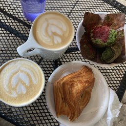 Lavender and rosemary latte, vegan matcha muffin with a raspberry center, and a feta and spinach croissant. Lavender and rosemary latte, vegan matcha muffin with a raspberry center, and a feta and spinach croissant.