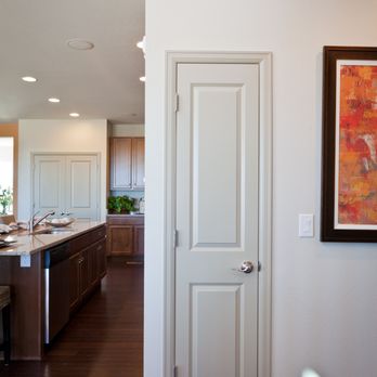 Builders FirstSource - White two panel interior door with brushed nickel handle in a modern home hallway, with a kitchen featuring dark wood cabinet... - Building Supplies Near Me - Steamboat Springs, Colorado Builders FirstSource - White two panel interior door with brushed nickel handle in a modern home hallway, with a kitchen featuring dark wood cabinet... - Building Supplies Near Me - Steamboat Springs, Colorado
