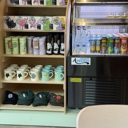 Merch and drinks at the counter.