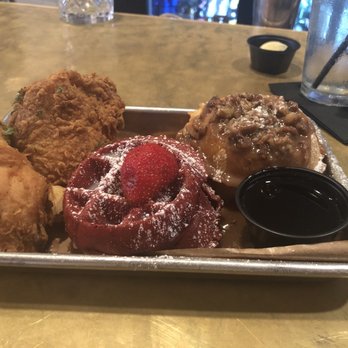 Taste Bar + Kitchen - Red velvet and Praline waffles with Cajun chicken - Cocktail Bars Near Me - Houston, Texas