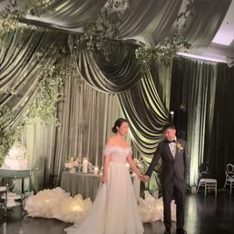 Magical drapery and greenery with uplighting, pinlights, and candle lights