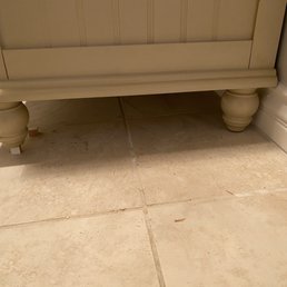 Small blocks of wood under the vanity feet to level it. Small blocks of wood under the vanity feet to level it.