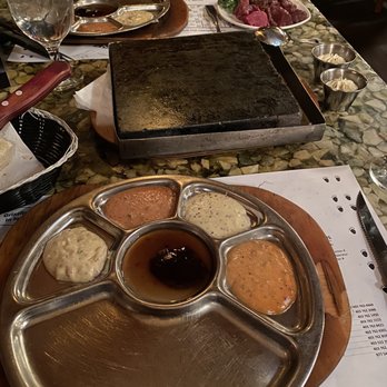 Grizzly House - Fondue dinner dipping sauces and hot stone to cook the protein on - Fondue Near Me - Banff, Alberta Grizzly House - Fondue dinner dipping sauces and hot stone to cook the protein on - Fondue Near Me - Banff, Alberta
