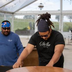 Mighty Movers & More - Assembling a farm tables for event setup.