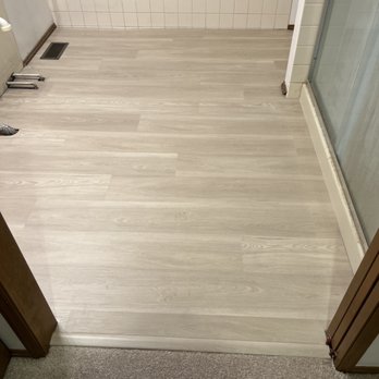 Renov8 NW - a view of a bathroom with a tub and shower - Flooring Near Me Renov8 NW - a view of a bathroom with a tub and shower - Flooring Near Me