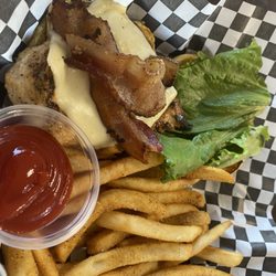 Eight Street Grill - Grilled chicken sandwich served with cheese, bacon, and lettuce. Regular fries with ketchup on the side.