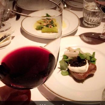 Le Coucou - Glass of red with veal tongue & caviar ($38) and leeks & hazelnut ($12) in the back - appetizers are a must here! - French Near Me - New York, New York Le Coucou - Glass of red with veal tongue & caviar ($38) and leeks & hazelnut ($12) in the back - appetizers are a must here! - French Near Me - New York, New York