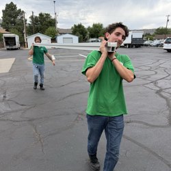 Employee carrying long metal bar