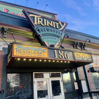 Trinity Brewhouse - The image depicts the storefront of Trinity Brewhouse in Providence, RI, with signage indicating it is a brewpub and restaurant, including details about its brewing and dining services. - American Near Me - Providence, Rhode Island