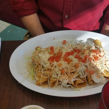 La Plaza Market - a plate of nachos with cheese and tomatoes - Grocery Near Me - Independence, Missouri