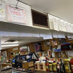 Numerous sandwich names pinned near the counter