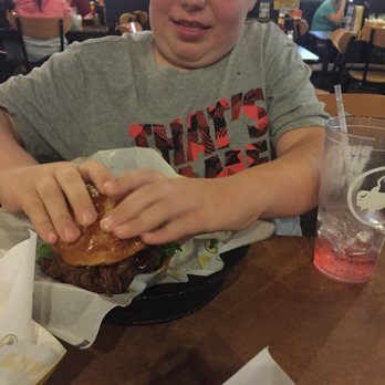 Buffalo Wild Wings - He didn't know how to eat it it was so big but really good. Definitely a mans burger like he wanted. - Chicken Wings Near Me - Visalia, California