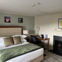 Inn at Mystic - Opening door, bed and fireplace to the right