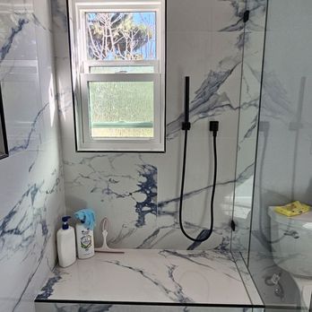 Superior Dream Remodels - Shower bench, handheld shower wand, and window view. - General Contractors Near Me - Chino Hills, California