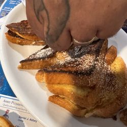 My Husband putting butter on his French toast