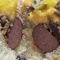 Momma Moodys Grinders - Dog On Grinder.  There's a 1/4 lb all beef hot dog under all that grinder meat, nacho cheese, and peppers!