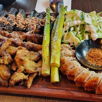 Jokim Kitchen - Saigon-style platter: house-made sausage, galagal pork, garlic beancurd lamb skewers, and bo la lot (betel leaf wrapped grilled beef) - Vietnamese Near Me - New Westminster, British Columbia