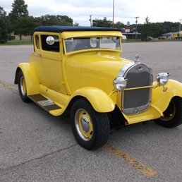 a yellow car in a parking lot