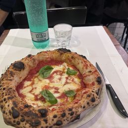 Traditional Margherita pizza and water Traditional Margherita pizza and water