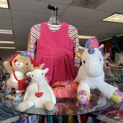 Rock It Resell - A hot-pink corduroy jumper over a rainbow-stripe long-sleeve tee, styled alongside three whimsical plush friends--a rainbow-eared bunny.