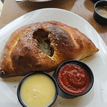 Sauce on the Side - Calzone with spicy marinara and garlic butter - Italian Near Me - Carmel, Indiana Sauce on the Side - Calzone with spicy marinara and garlic butter - Italian Near Me - Carmel, Indiana