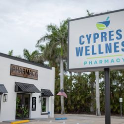 Cypress Wellness Pharmacy - Pharmacy and road sign