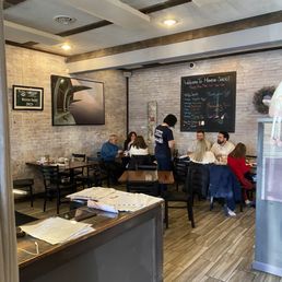 people sitting at tables in a restaurant