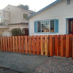 a wooden fence in front of a house
