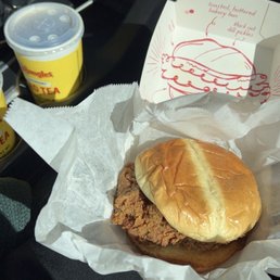 a sandwich and a drink in a car a sandwich and a drink in a car