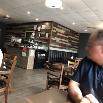 Perogy On A Fork - a man sitting at a table in a restaurant - Ukrainian Near Me - Glendon, Alberta