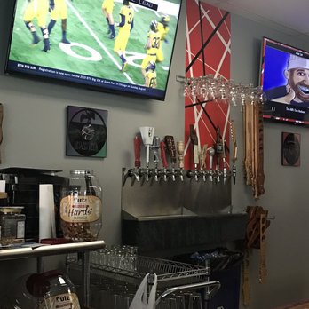 Rock God Brewing - Taps and TVs behind the bar. The far one shows the upcoming food trucks. - Brewpubs Near Me - Danville, Pennsylvania Rock God Brewing - Taps and TVs behind the bar. The far one shows the upcoming food trucks. - Brewpubs Near Me - Danville, Pennsylvania
